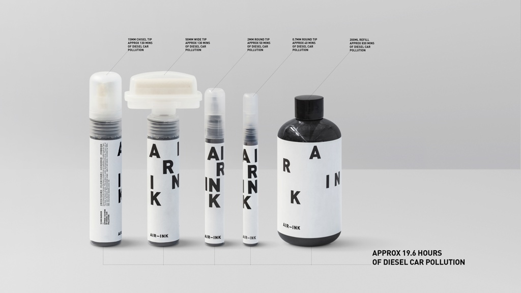 A photograph of black captured carbon material in pens, markers and a bottle with applicators of different widths is placed horizontally in an installation view with descriptions of the contents above each container to the right. The label contains a black block lettered font with a ground that is contrasted in white and the placement of the letters is consistently irregular on each receptacle.