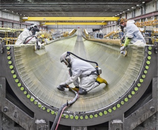 Photograph, Sanding infused fiberglass inside a wind turbine blade