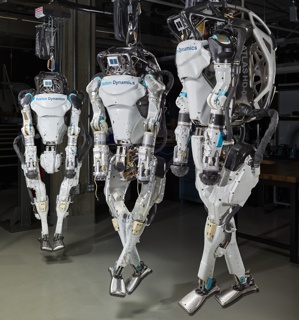 Photograph, Dave Lin installing a motor controller into the arm of Apollo 1™, a humanoid robot