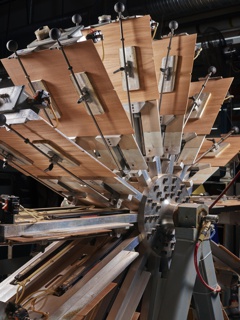 Photograph, John Machado, pressman, performing weekly maintenance inside a printing press unit