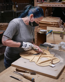 Photograph, Christopher Aparicio unpacking crucibles after heating graphite cores in an oven