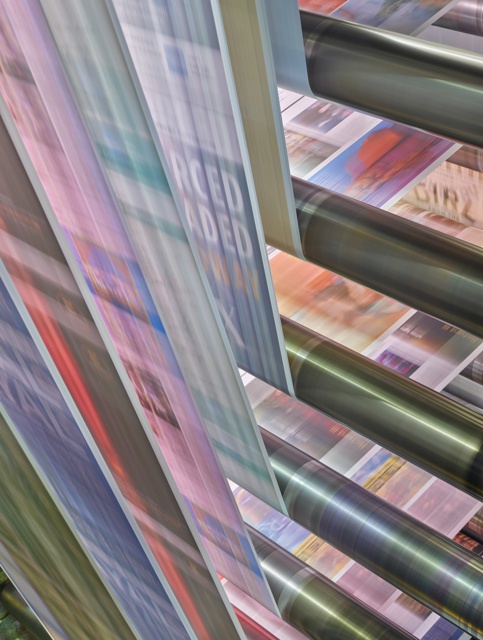 Photograph, A four-page-wide continuous web of paper runs through the printing press