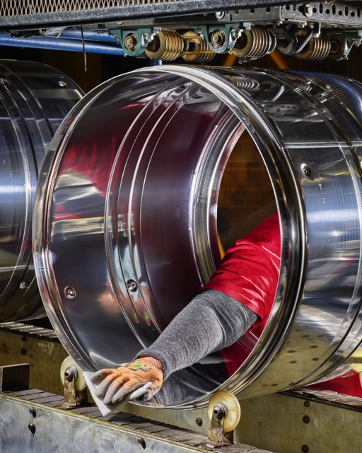 Photograph, Inspecting a stainless steel dryer drum