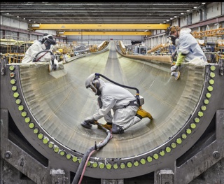 Photograph, Sanding infused fiberglass inside a wind turbine blade