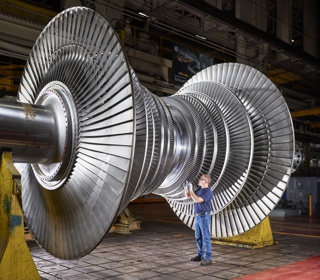 Photograph, Ron Folmsbee inspecting a low-pressure steam turbine rotor