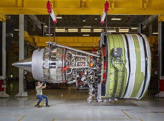 Photograph, Christina Akers prepping a GE90 jet engine for testing