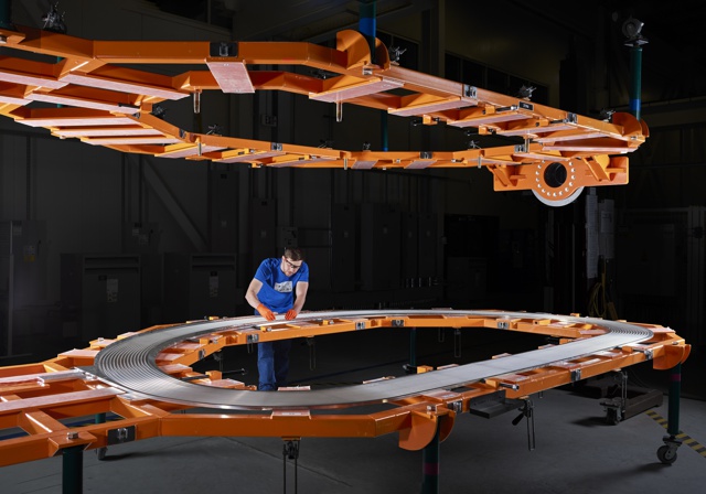 Photograph, Josh Morrison assembling the inner track on the D-shaped superconducting magnet for the fusion device SPARC