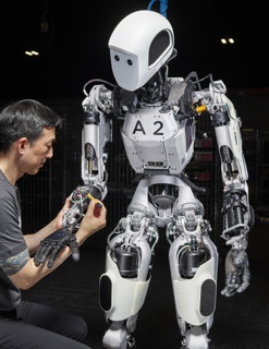Photograph, Dave Lin installing a motor controller into the arm of Apollo 1™, a humanoid robot