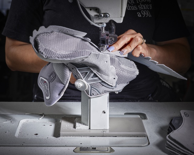 Photograph, Yanet Portes sewing parts of the 990 running shoe upper together