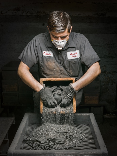 Photograph, Christopher Aparicio unpacking crucibles after heating graphite cores in an oven