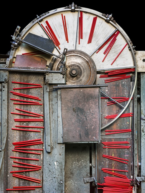 Photograph, Painted pencils drying on conveyor belt