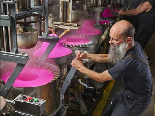 Photograph, Pulling machine operator James Conard establishing crown depth, brim width and proper size for pink Bailey western hat