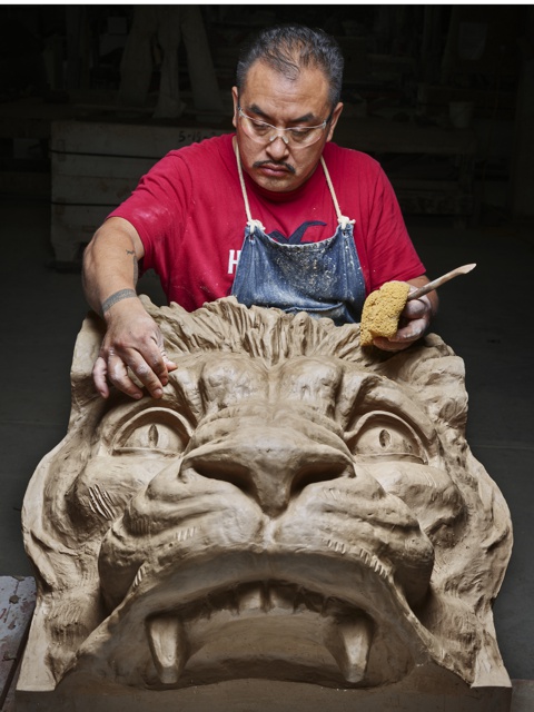 Photograph, Raul Gonzales hand-finishing a terra-cotta lion head for the Flatiron Building, New York City